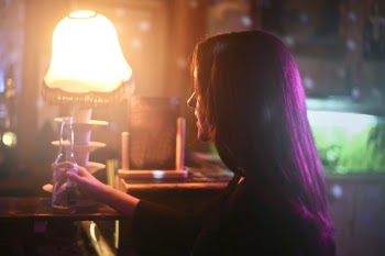 Photography of a Woman Holding Beer Bottle