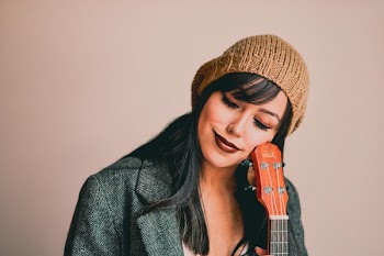 Photography of a Woman Holding Ukelele