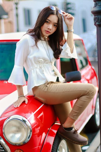 Photography of a Woman Leaning on the Car