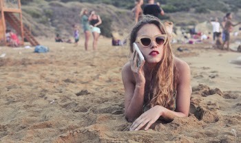 Photography of a Woman Lying on Sand
