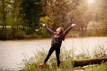 Photography of a Woman Near Lake