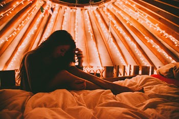 Photography of a Woman on White Bed Linen