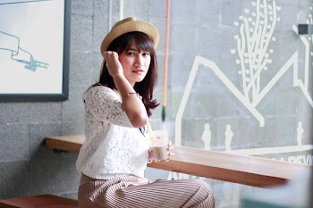 Photography of a Woman Sitting on Bench