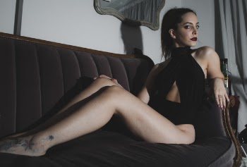 Photography of a Woman Sitting on Couch