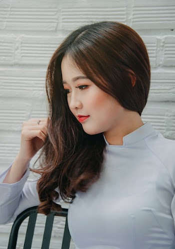 Photography of a Woman Touching Her Hair