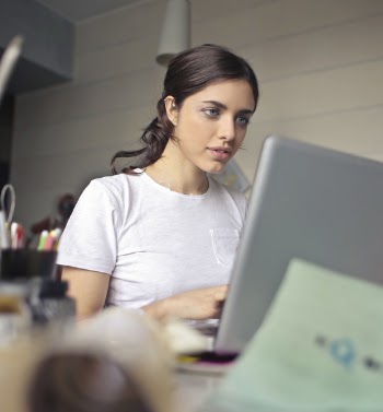 Photography of a Woman Using Laptop