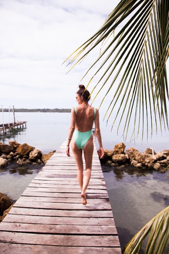 Photography of a Woman Walking on the Dock