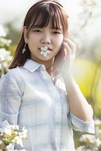 Photography of a Woman With Flower on Her Mouth