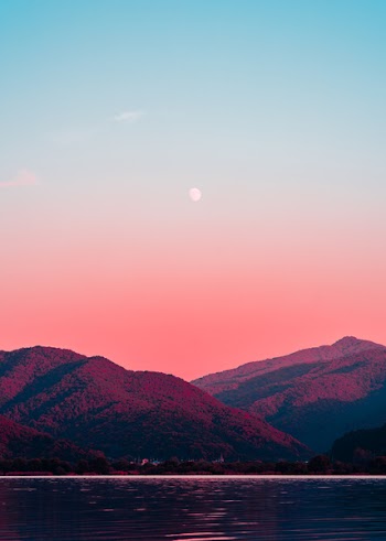 Photography of Body of Water and Mountains