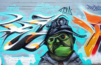 Photography of Brick Wall With Graffiti