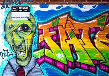 Photography of Brick Wall With Graffiti
