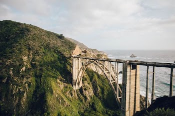 photography of bridge on mountain