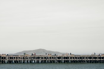 photography of concrete bridge near the body of water