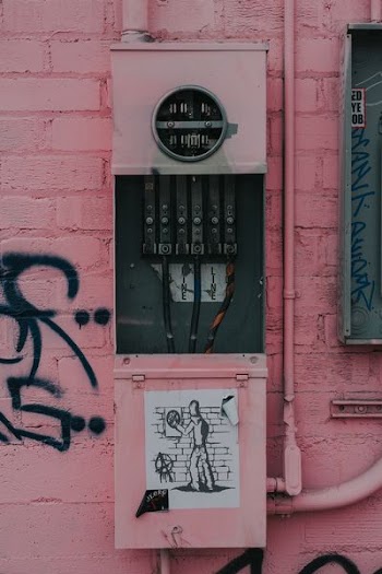 photography of distribution board with graffiti sticker