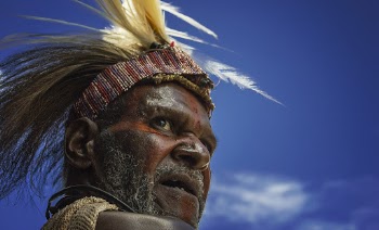 Photography of Man in Feather Headband