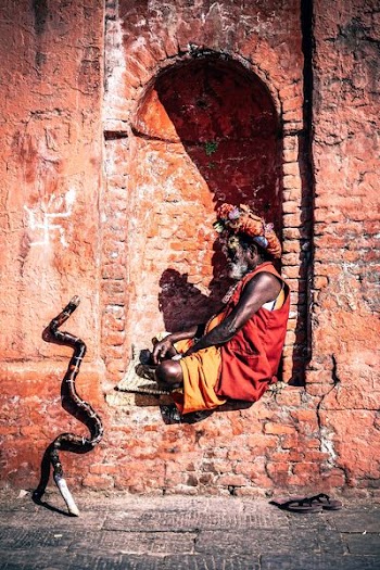 photography of man sitting on wall