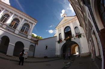 Photography of Man Standing While Holding Camera Front of Building