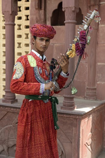 Photography of Man Wearing Red Traditional Dress