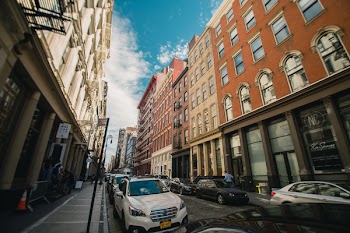 Photography of Parked Cars Between City Buildings