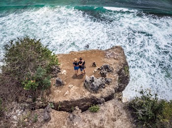 Photography of People Standing Near Cliff