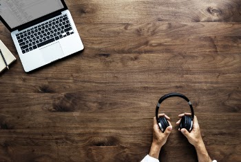 Photography of Person Holding Headphone