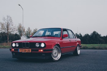 Photography of Red BMW On Asphalt Road