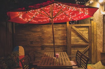 Photography of Red Patio Table With String Lights