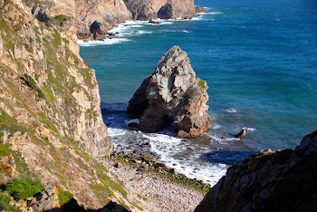 Photography of Rock Formation Beside Body of Water
