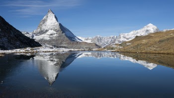Photography of Snow Mountains Near Lake