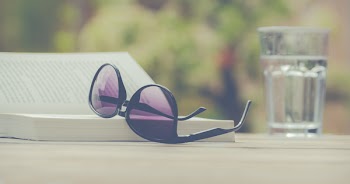 Photography of Sunglasses Near Book