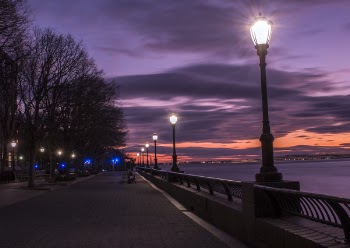 Photography of Turned on Street Lamps Beside Bay during Night Time