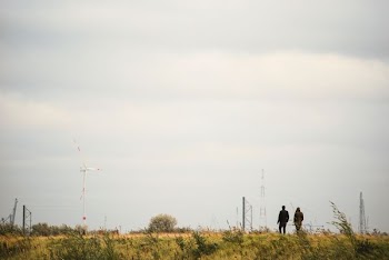 photography of two people walking on road