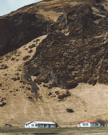 Photography of Two White Buildings Beside Mountain Range