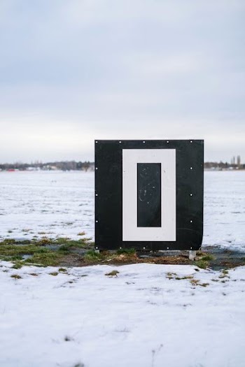 photography of white and black container on field