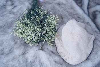 Photography of White Hat Near White Flowers