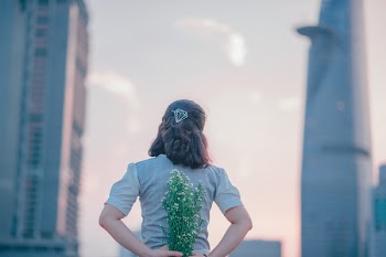 Photography of Woman Holding White Flowers