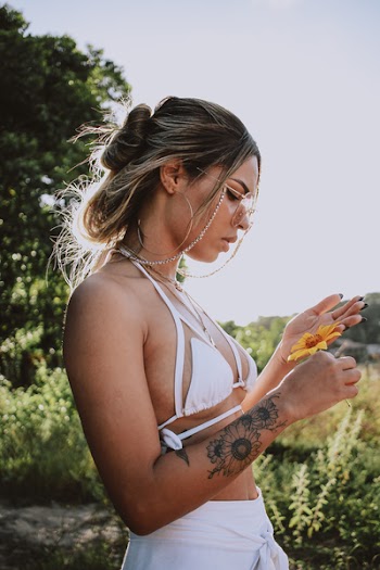 Photography of Woman Holding Yellow Flower