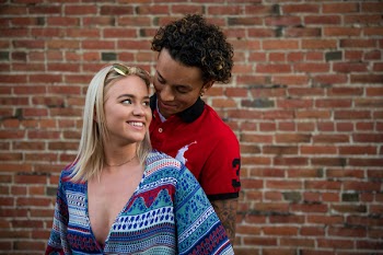 Photography of Woman in Front of Man in Red Polo Shirt