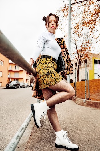 Photography of Woman Leaning on Gray Metal Rail