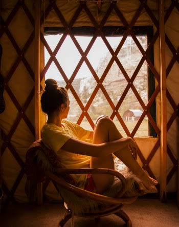 Photography Of Woman Sitting On Brown Wicker Chair During Sunset