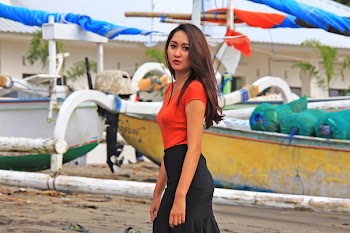 Photography of Woman Standing Next to Yellow and White Boats