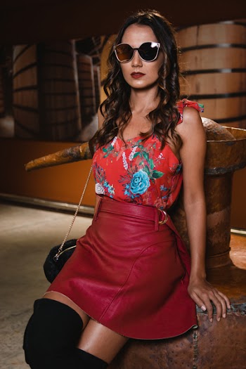 Photography of Woman Wearing Floral Top and Red Leather Skirt