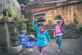 Photography of Women Carrying Cinder Blocks
