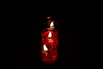 Photography Three Tealight Candles in Dark Place