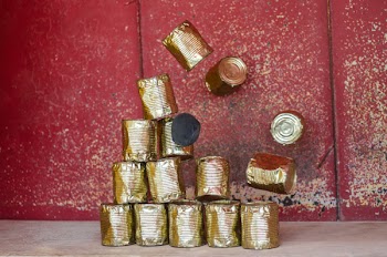 Pile Brass-colored Cans on Beige Surface