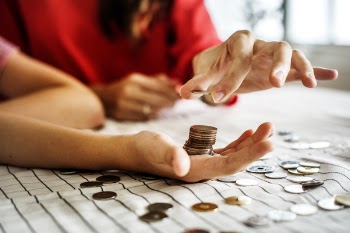 Pile of Coins on Person's Palm