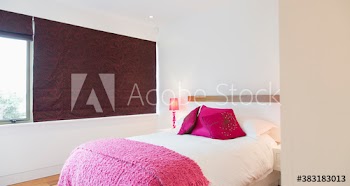 Pillows and throw on bed in guest bedroom