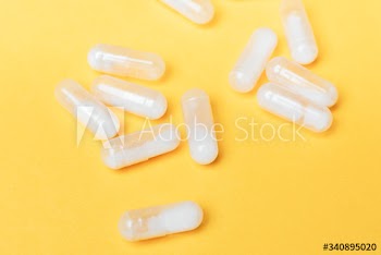 Pills and medication on a yellow background