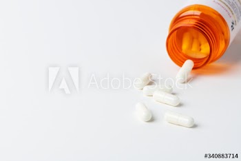 Pills for viral disease spilled from a bottle