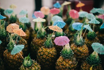 Pineapple Fruits With Paper Umbrellas On Top
